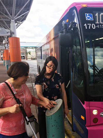 An Orientation Mobility Instructor walking a client through using a LYNX bus