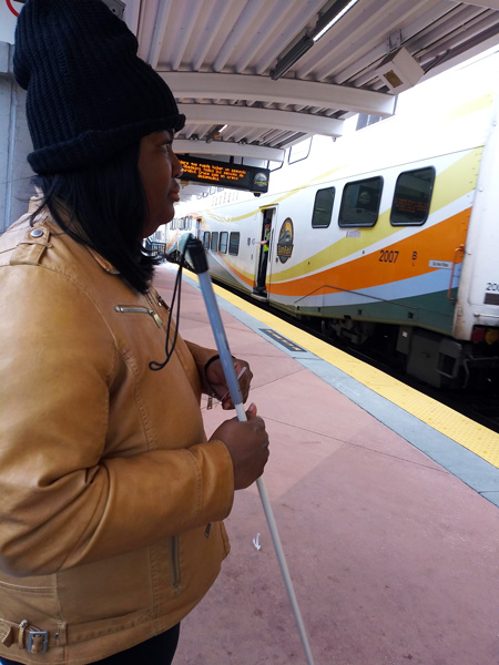 An Orientation and Mobility client waiting at a SunRail station