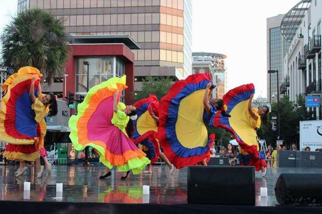 Lighthouse staffer, Maria, leads her Colombian folk dance troupe during recent performance.