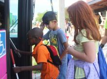 Three Lighthouse Academy Students getting on a LYNX bus together
