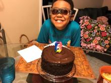 Children's program student, Basil B., seen here celebrating his 8th birthday with a chocolate cake