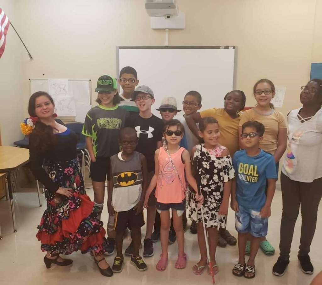 Lighthouse staffer, Maria [far left], poses with Lighthouse Academy students following a lesson on dance