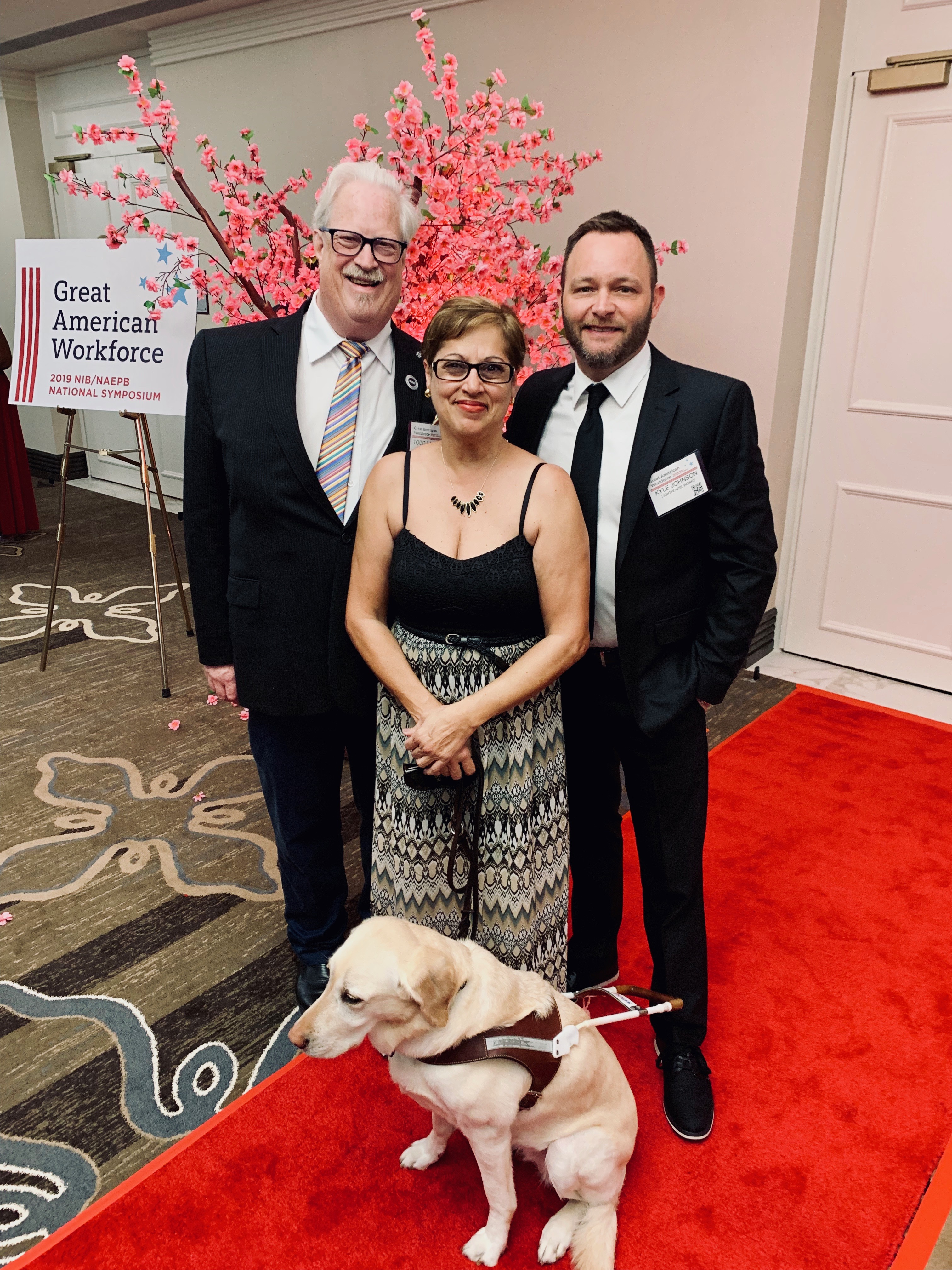 Todd posing with coworker Norma and Lighthouse President and CEO Kyle Johnson