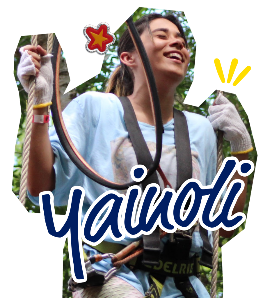 1 A teen girl smiles and looks upward while climbing on a ropes course with a safety harness and gloves.