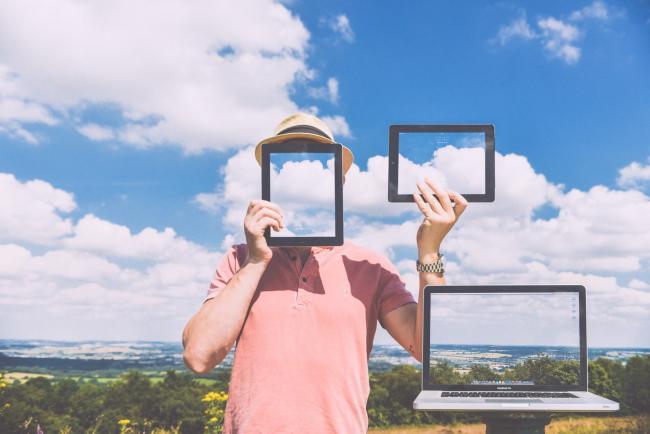 A man outside with a cloud background holding a tablet in front of his face and holding up another tablet to the side in his other hand. The tablets show images that blend into the cloud backgroundToday, Thursday May 18th, is Global Accessibility Awareness Day. This year marks the sixth Global Accessibility Awareness Day (GAAD). The purpose of GAAD is to get everyone talking, thinking and learning about digital (web, software, mobile, etc.) access/inclusion and people with different disabilities.