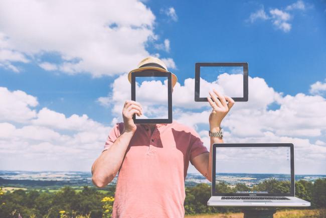 A man outside with a cloud background holding a tablet in front of his face and holding up another tablet to the side in his other hand. The tablets show images that blend into the cloud backgroundToday, Thursday May 18th, is Global Accessibility Awareness Day. This year marks the sixth Global Accessibility Awareness Day (GAAD). The purpose of GAAD is to get everyone talking, thinking and learning about digital (web, software, mobile, etc.) access/inclusion and people with different disabilities. 