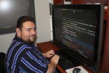 picture of Mike Fox working at his computer on some code for a project