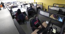 Image of Lighthouse Works contact center agents working at their desks taking calls